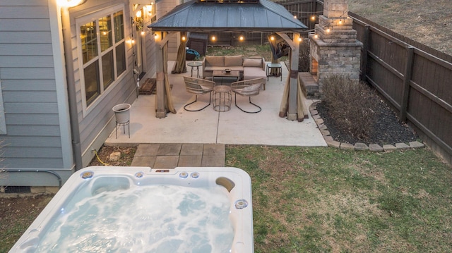 view of patio with an outdoor living space and a hot tub