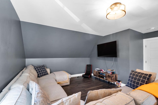 living area featuring baseboards, lofted ceiling, and wood finished floors