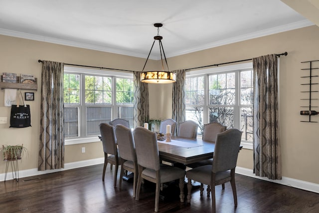 dining room with ornamental molding, baseboards, and dark wood-style flooring