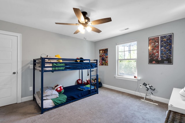 bedroom with visible vents, carpet floors, baseboards, and a ceiling fan