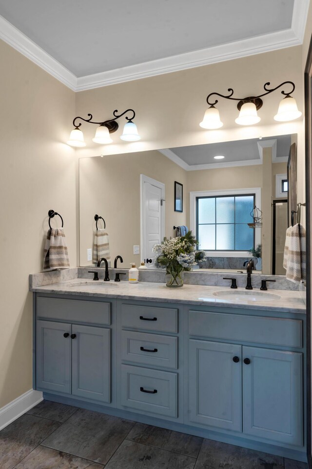 full bathroom with crown molding, double vanity, and a sink