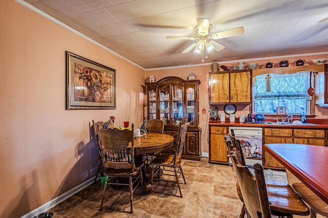 dining space with ceiling fan, sink, and ornamental molding