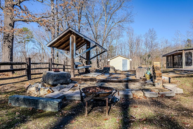 view of yard featuring a fire pit and a shed