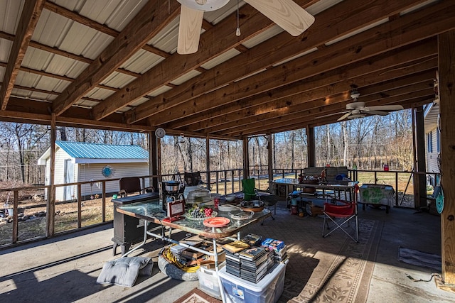 view of patio / terrace featuring ceiling fan and a storage unit