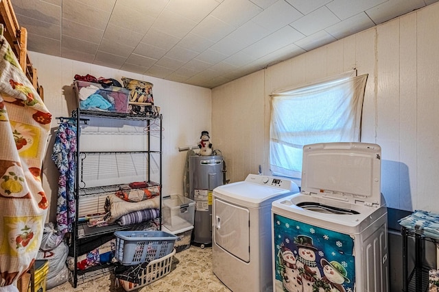 washroom with washer / clothes dryer, electric water heater, and wood walls