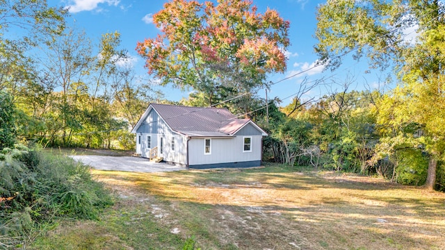 view of side of property with a lawn