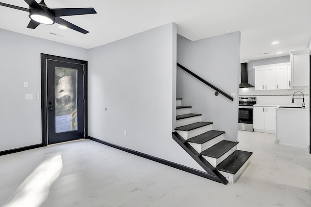 entrance foyer with ceiling fan and sink