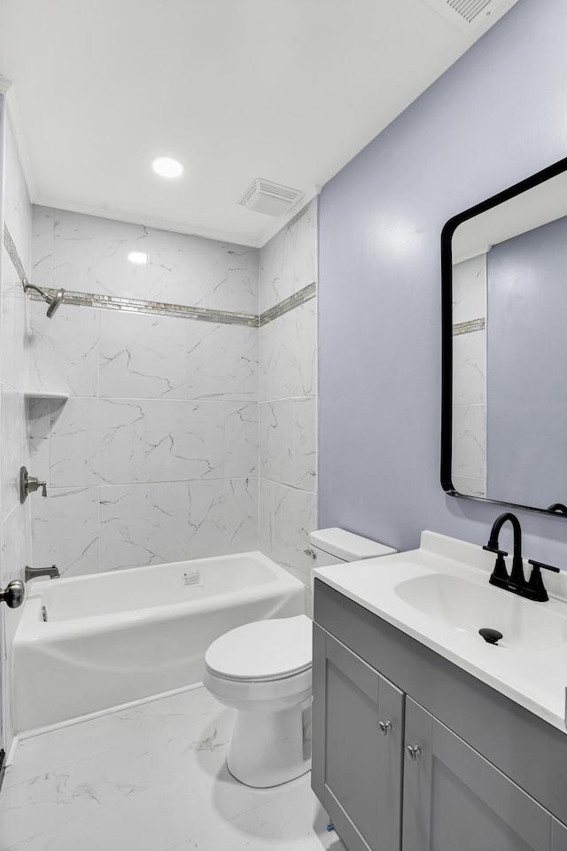 full bathroom with vanity, tiled shower / bath combo, and toilet