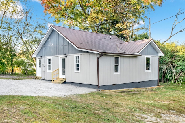 view of side of home with a lawn