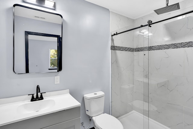 bathroom featuring vanity, a shower with shower door, and toilet