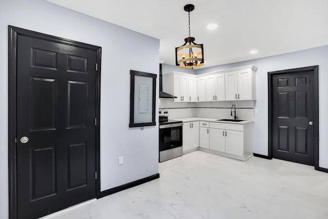 kitchen with stainless steel range with electric stovetop, wall chimney range hood, sink, decorative light fixtures, and white cabinetry