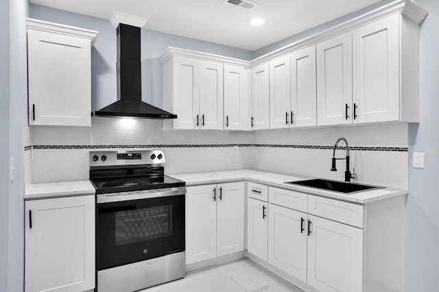 kitchen with white cabinets, stainless steel range with electric stovetop, wall chimney exhaust hood, and sink