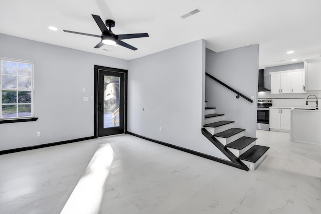 entrance foyer with ceiling fan and sink