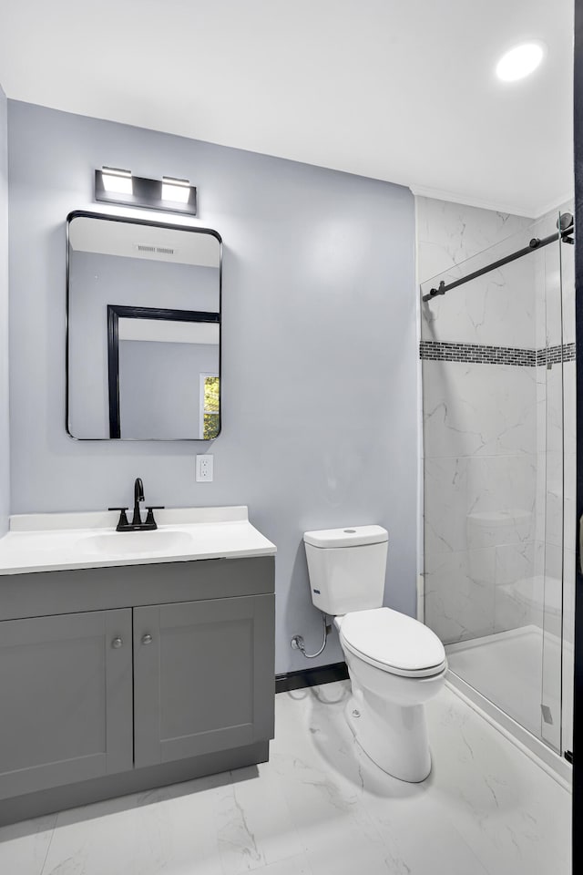 bathroom featuring a tile shower, vanity, and toilet