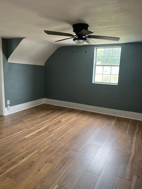 bonus room featuring wood-type flooring, ceiling fan, and lofted ceiling