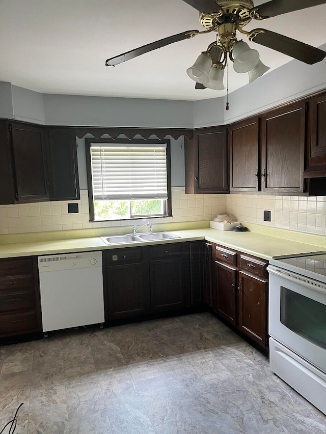 kitchen with dark brown cabinets, white appliances, backsplash, and sink