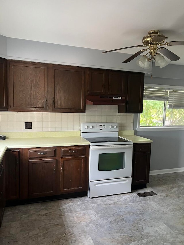 kitchen with white range with electric stovetop, backsplash, ceiling fan, and dark brown cabinets