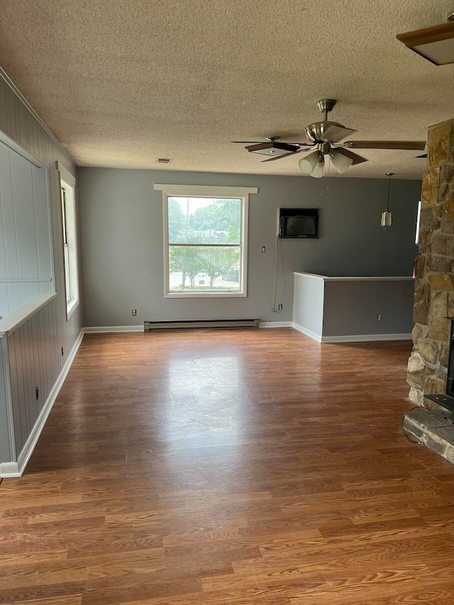 unfurnished living room with a textured ceiling and hardwood / wood-style flooring