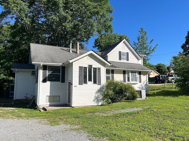 view of front of house with cooling unit and a front yard