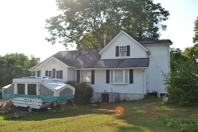 rear view of house featuring a yard and central AC