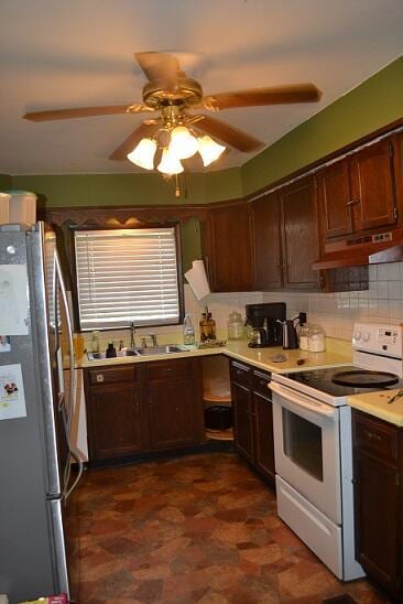 kitchen with tasteful backsplash, ceiling fan, sink, white electric stove, and stainless steel refrigerator