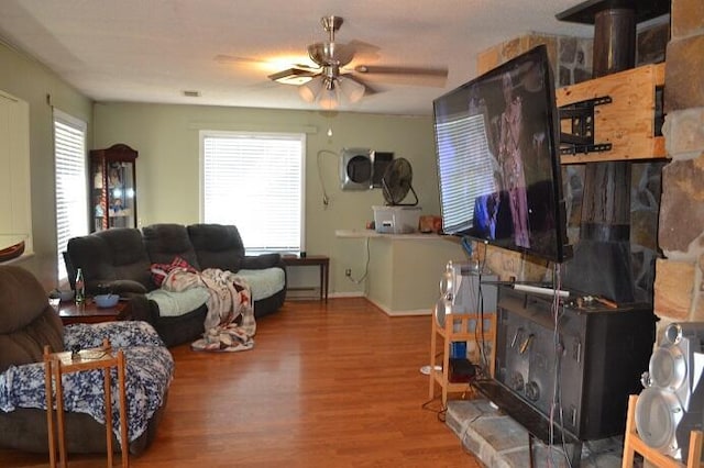 living room featuring ceiling fan, a healthy amount of sunlight, and wood-type flooring