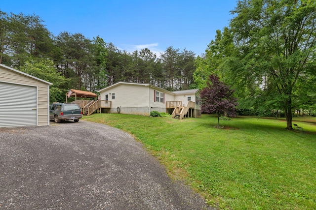 393 Friendship Ln, Delano, TN 37325 - view of front of home with stairs, a front lawn, a deck, and driveway