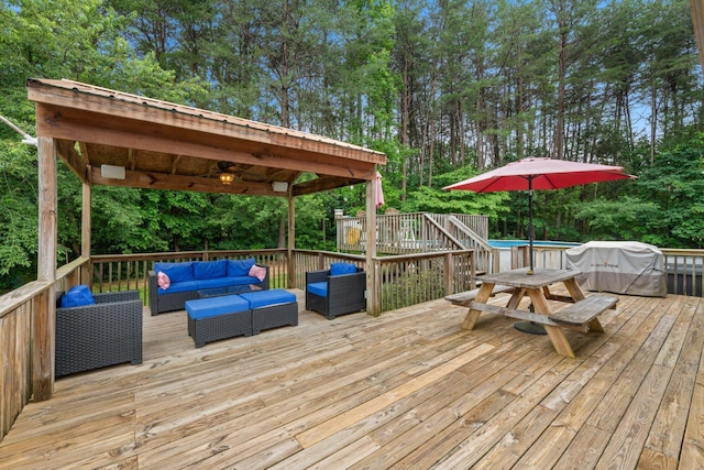 393 Friendship Ln, Delano, TN 37325 - wooden terrace with an outdoor hangout area, an outdoor pool, grilling area, and view of wooded area