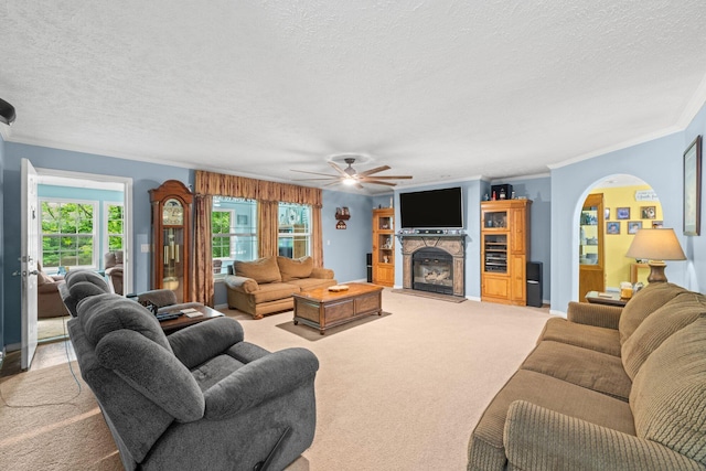 393 Friendship Ln, Delano, TN 37325 - living area featuring light colored carpet, ornamental molding, a textured ceiling, a stone fireplace, and ceiling fan