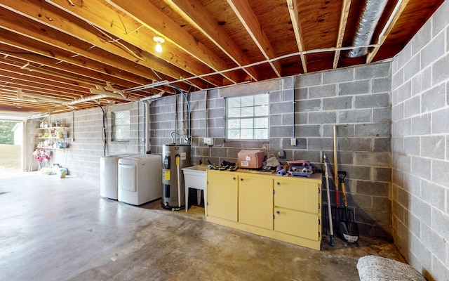 basement with electric water heater and washer and dryer