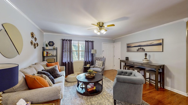 living room featuring wood-type flooring, ornamental molding, and ceiling fan