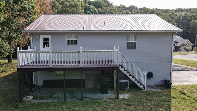 rear view of property with a wooden deck and central AC