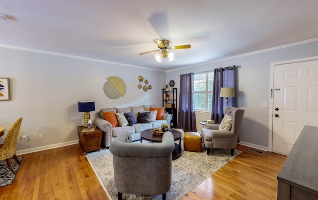 living room with ornamental molding, ceiling fan, and light hardwood / wood-style floors