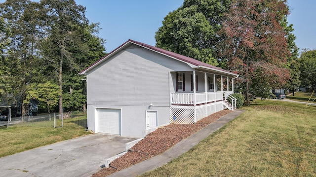 view of home's exterior featuring a yard, a garage, and a porch