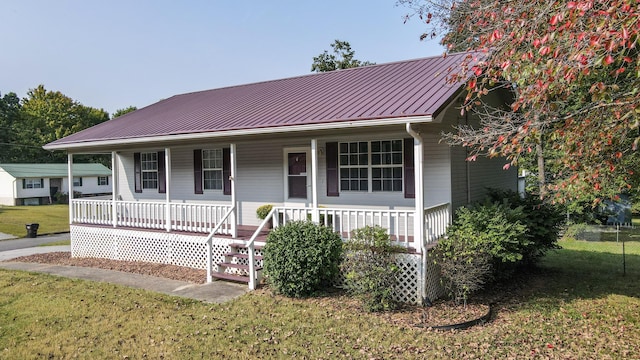 view of front of home with a porch and a front lawn