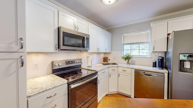 kitchen with ornamental molding, stainless steel appliances, sink, and white cabinets