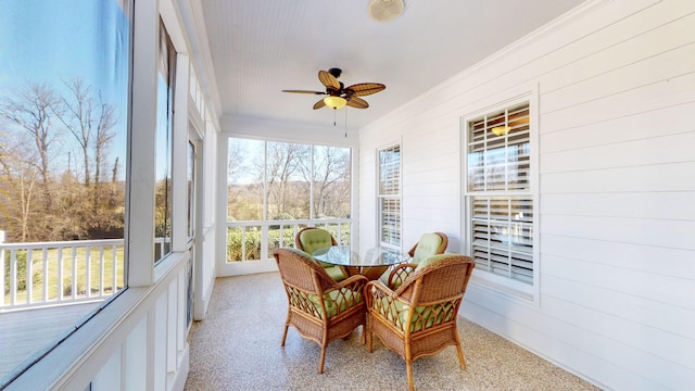 sunroom featuring ceiling fan