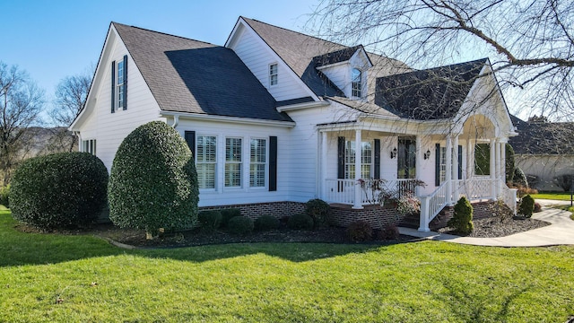 view of front of property with covered porch and a front lawn