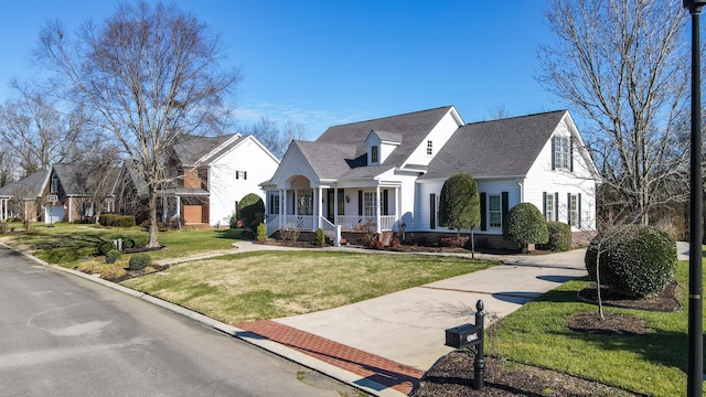 cape cod home with a front lawn and covered porch