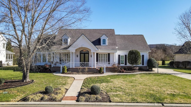 cape cod house featuring french doors and a front yard