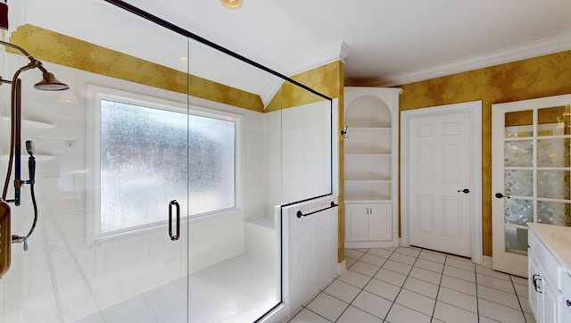 bathroom featuring vanity, tile patterned floors, an enclosed shower, and crown molding