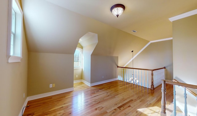 bonus room featuring vaulted ceiling and light hardwood / wood-style flooring