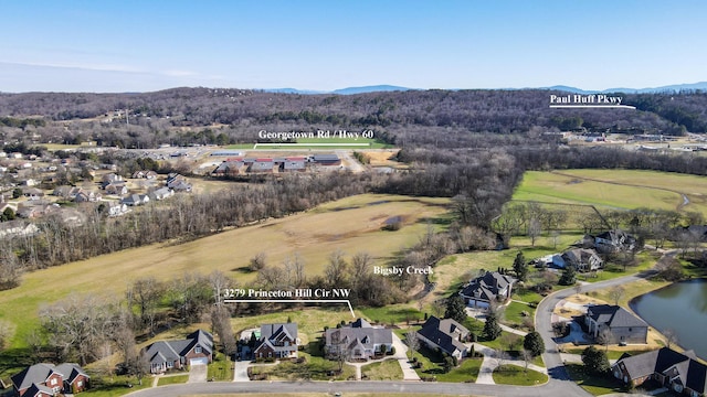 drone / aerial view with a water and mountain view