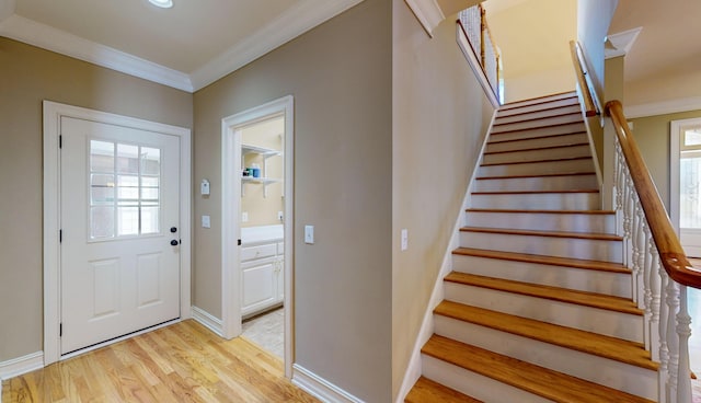 entryway featuring light hardwood / wood-style floors and ornamental molding