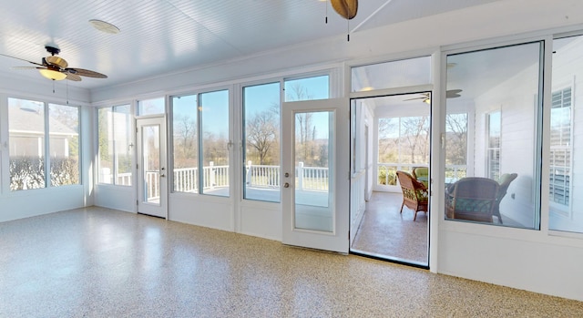 unfurnished sunroom with ceiling fan and french doors