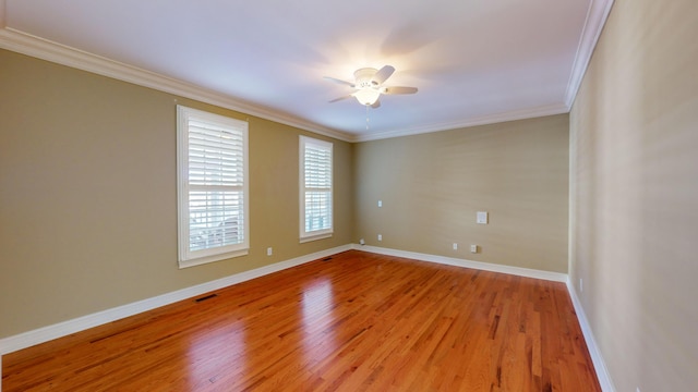 unfurnished room with ceiling fan, light hardwood / wood-style flooring, and ornamental molding