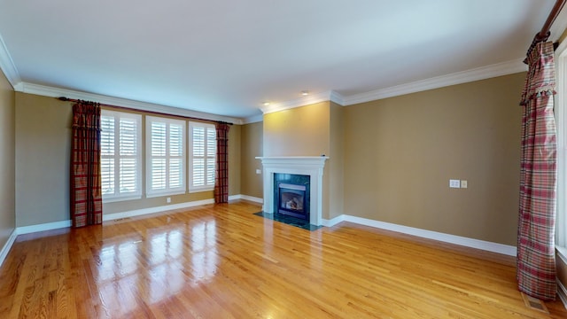 unfurnished living room with light wood-type flooring and crown molding