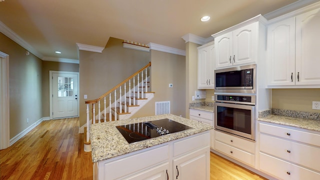 kitchen featuring light stone counters, crown molding, light hardwood / wood-style floors, white cabinets, and appliances with stainless steel finishes