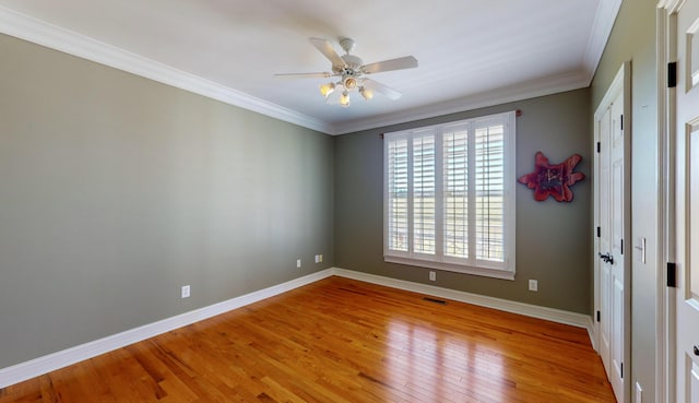 spare room with ceiling fan, ornamental molding, and light hardwood / wood-style flooring