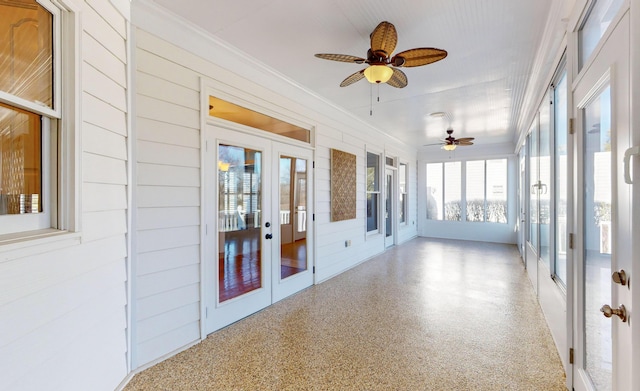 unfurnished sunroom with french doors and ceiling fan